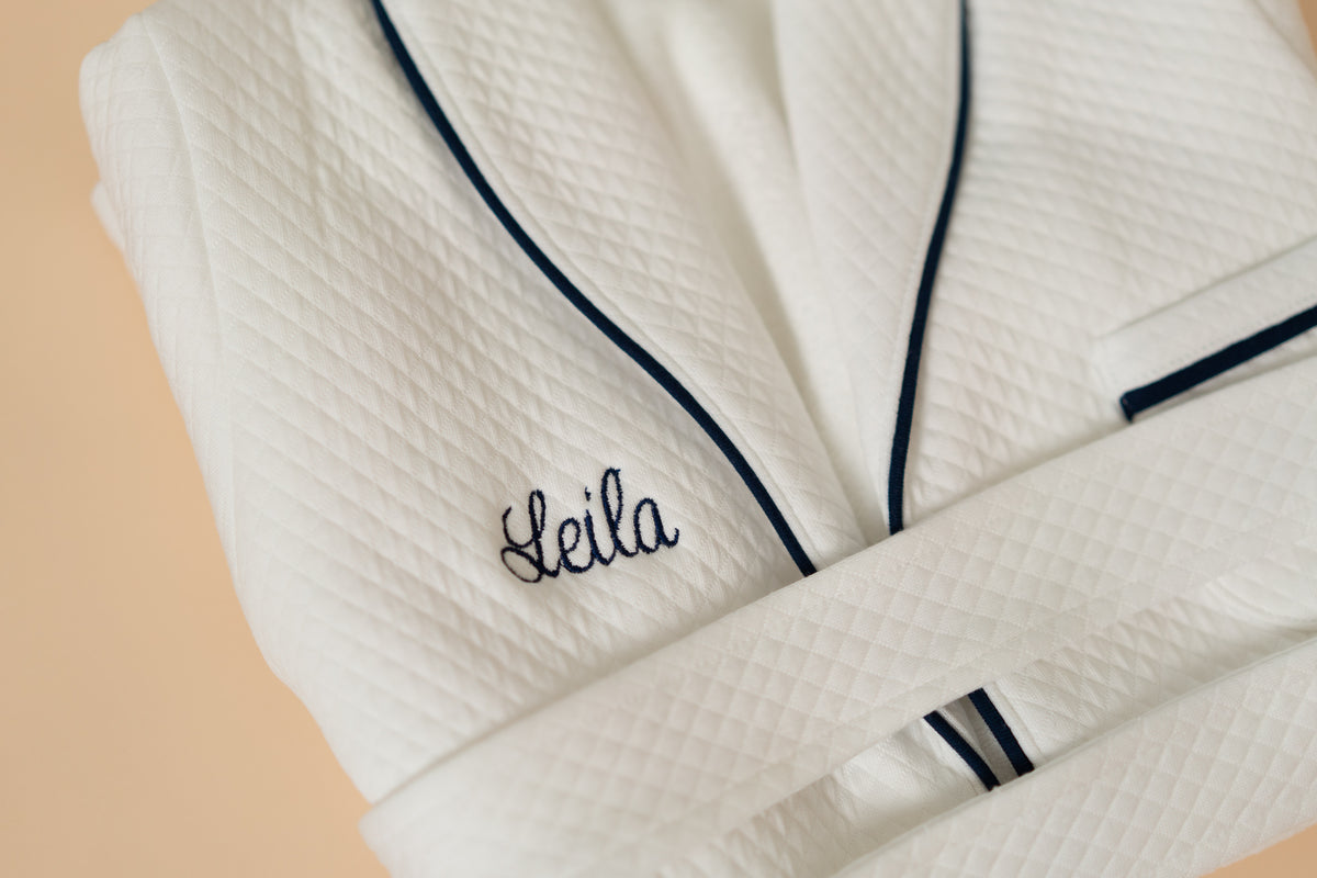 White quilted Pima cotton kids bathrobe with navy piping by Pipa & Pierre